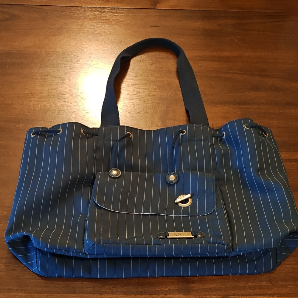 Ogio navy blue pinstripe bag with flower lining gently used